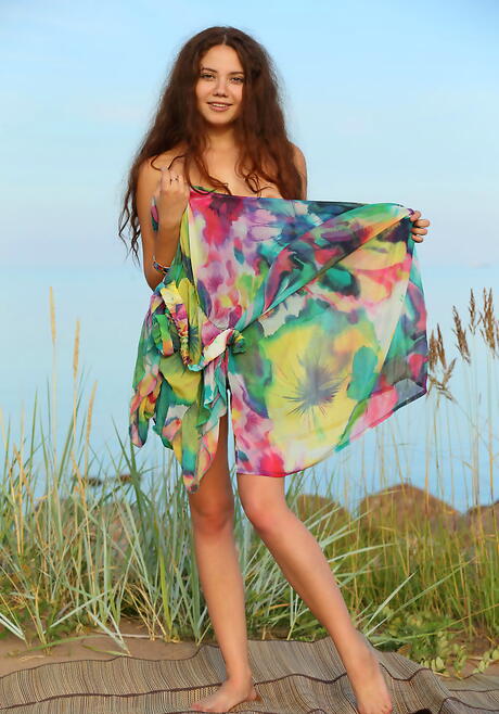 Foxy redhead teen Norma A in fancy skirt reveals her butt and bald pussy outdoor